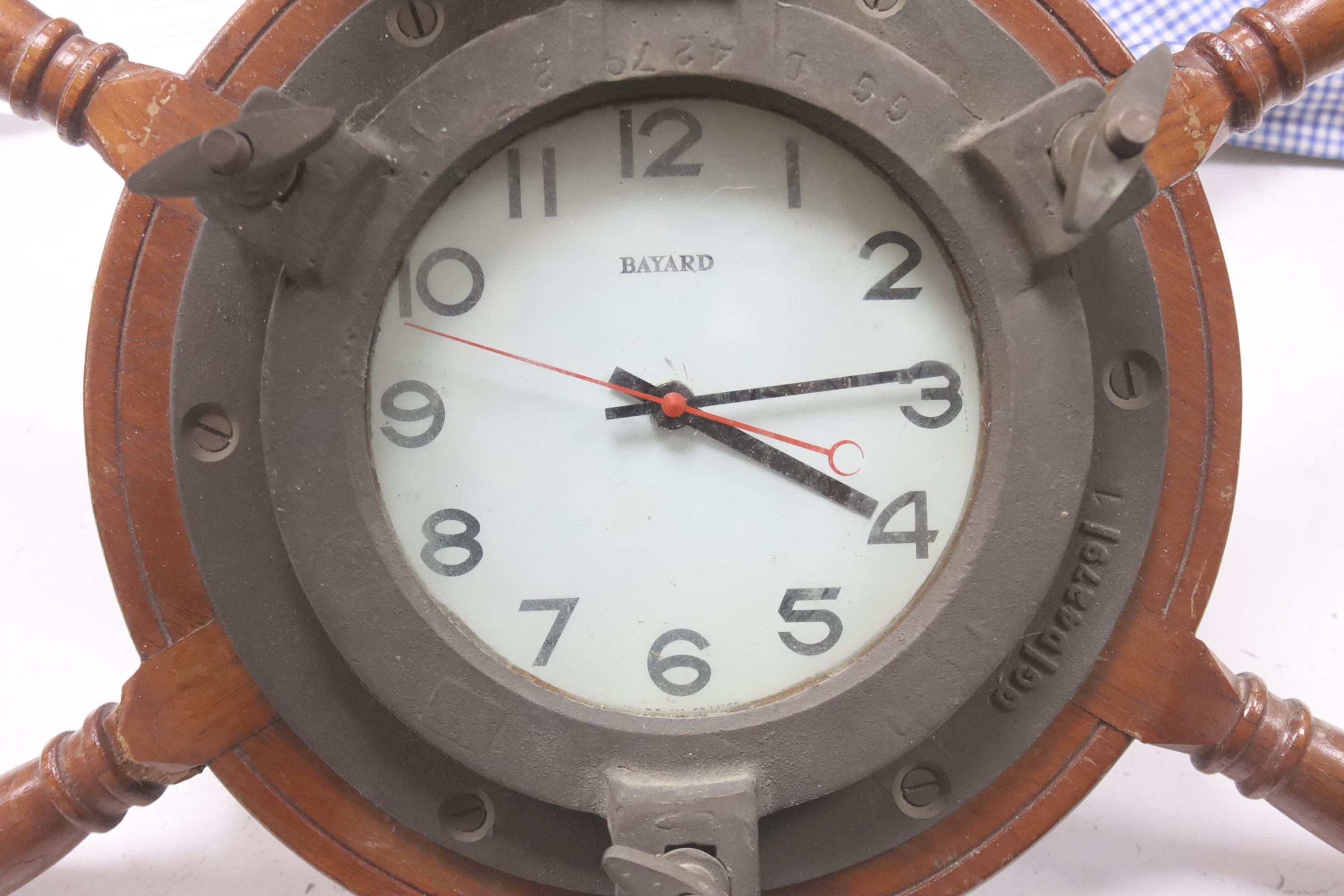 A brass bulkhead timepiece, enamelled dial signed Story, Barrow, dial 17cm, and a ship's wheel wall timepiece by Bayard
